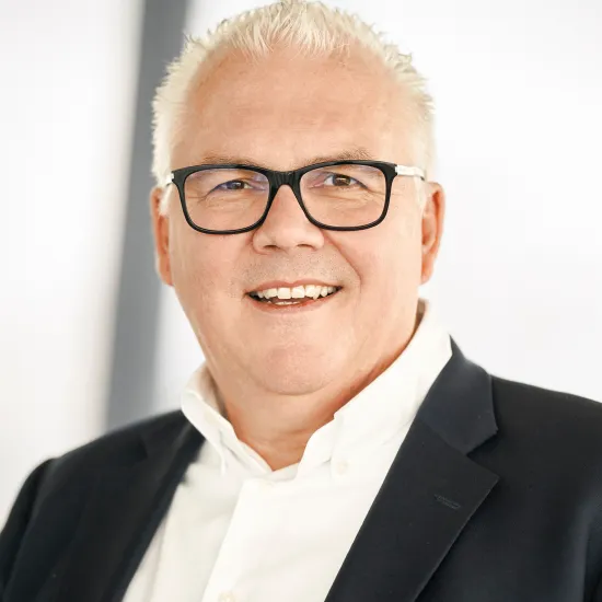 a man wearing glasses and a suit